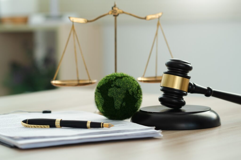 Law international environmental concept.world and wooden gavel with a golden scale.